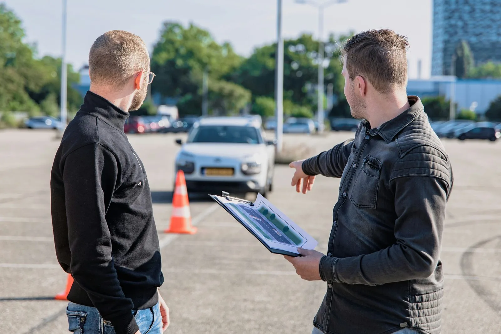 Orchard Driving School instructor with student preparing dual-control vehicle at registry for road test Edmonton